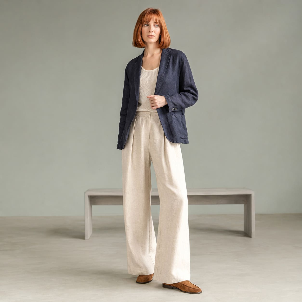 Navy lightweight jacket worn with cream wide-leg trousers, sample image
