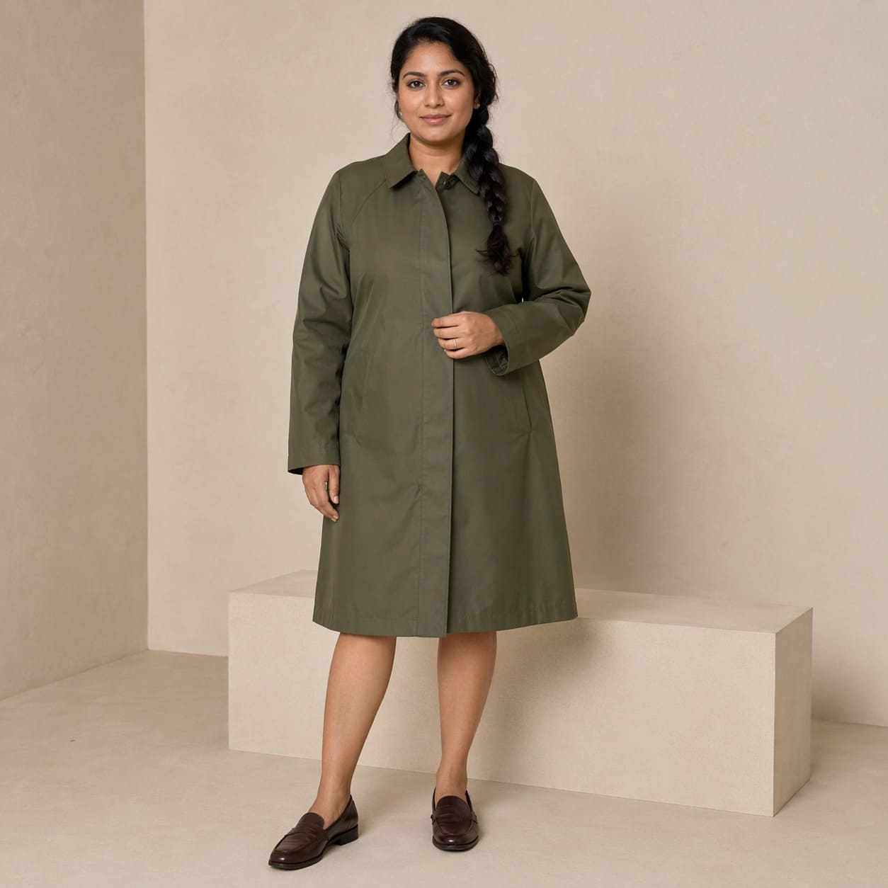 Olive green longline coat with button detailing, sample image