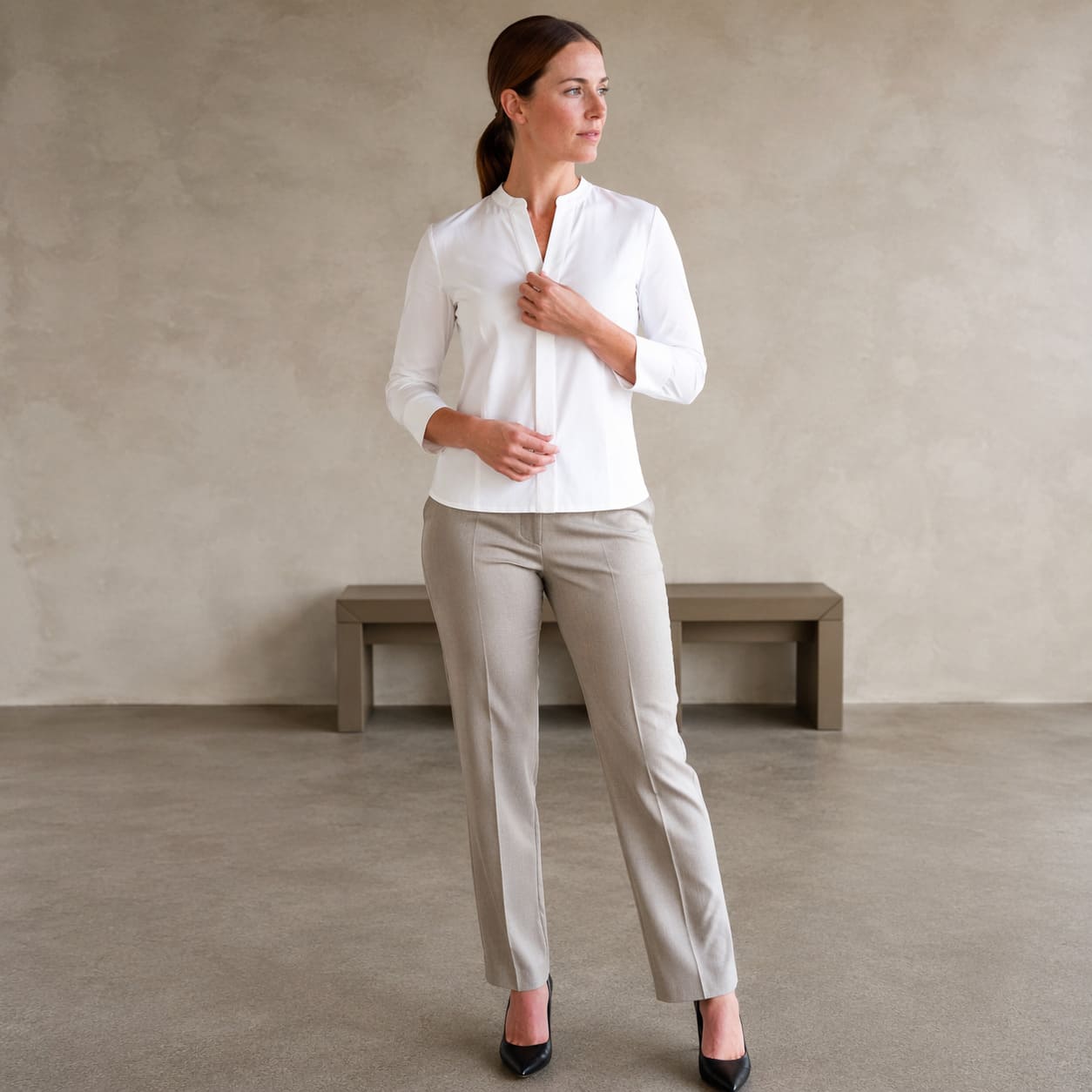 White button up blouse worn with slim fit trousers