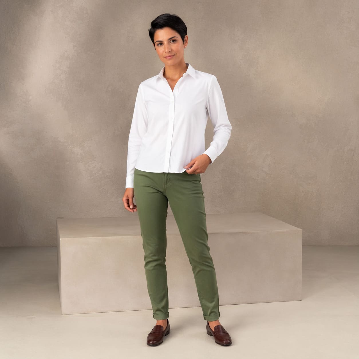 White button-up shirt worn with green slim-fit trousers, sample image