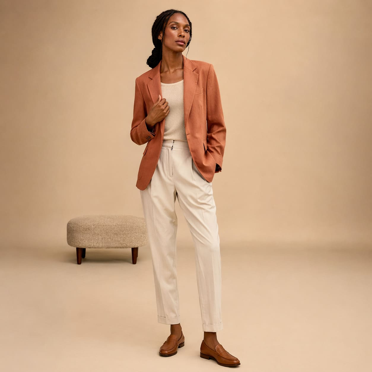 Rust blazer worn with a cream top and relaxed trousers, sample image
