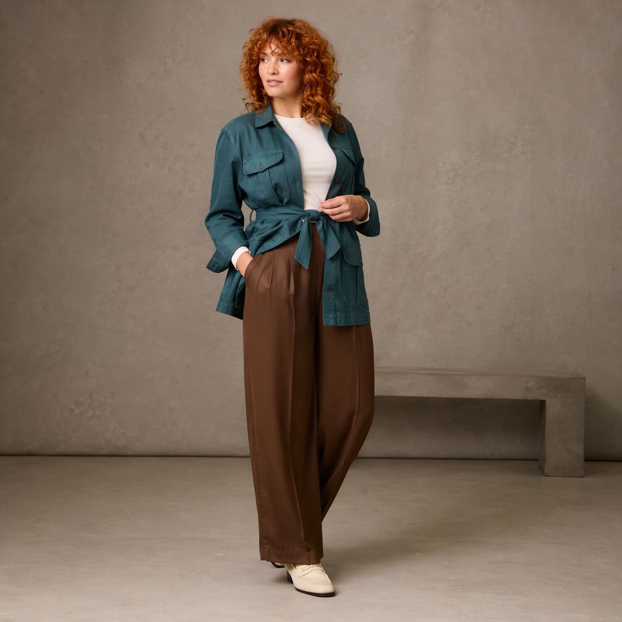 Teal blazer worn with a white top and brown wide-leg trousers, sample image