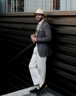 Brown linen jacket wide grey trousers straw hat