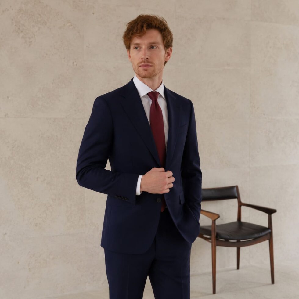 Navy made-to-measure suit worn with a burgundy tie, sample image