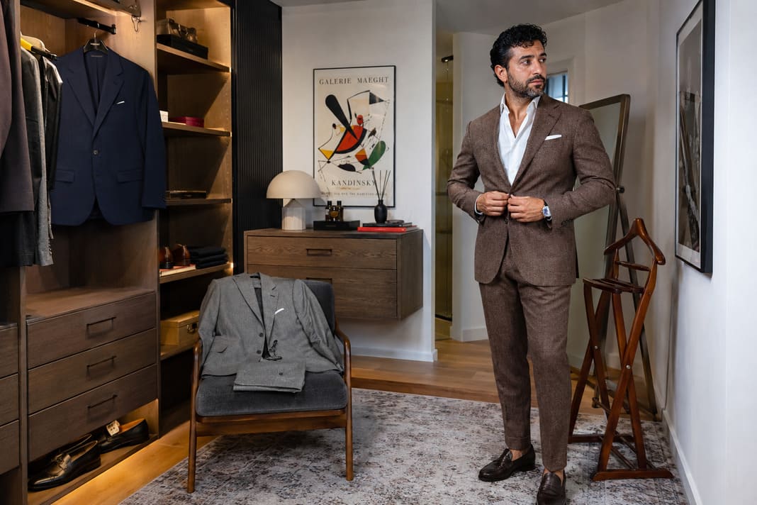 A rich brown tailored suit styled with a white dress shirt demonstrates one of the essential options in a three suit wardrobe, offering a versatile choice for business, weddings and smart casual occasions. A rich brown tailored suit styled with a white dress shirt demonstrates one of the essential options in a three suit wardrobe, offering a versatile choice for business, weddings and smart casual occasions.