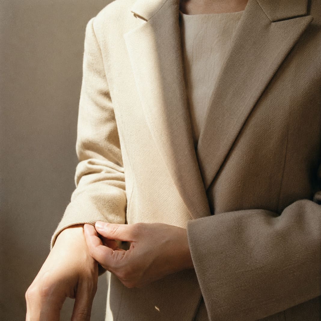 Fitting appointment adjusting a bespoke jacket for the fit.
