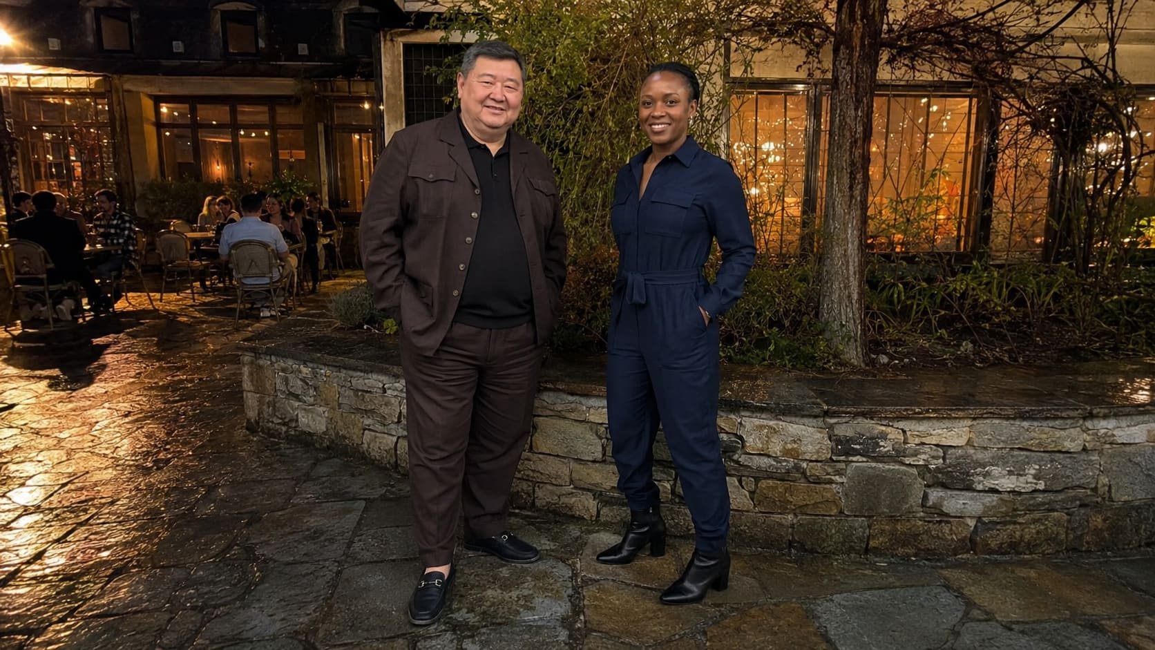 Man and woman wearing brown and navy tailoring stand outdoors in heavier fabrics suited to September.