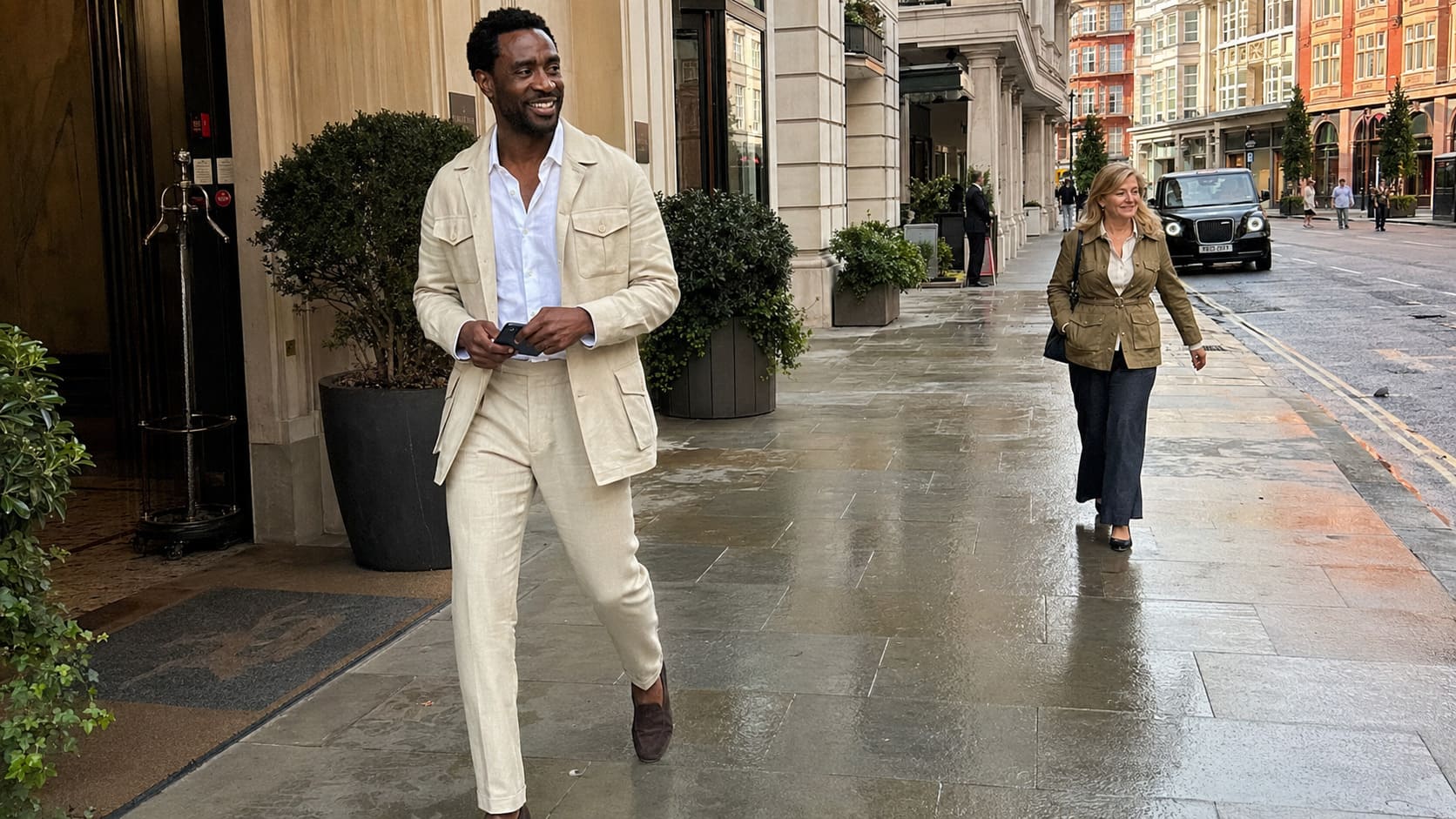 Man wearing cream suit demonstrates the final weeks of linen before switching to wool.