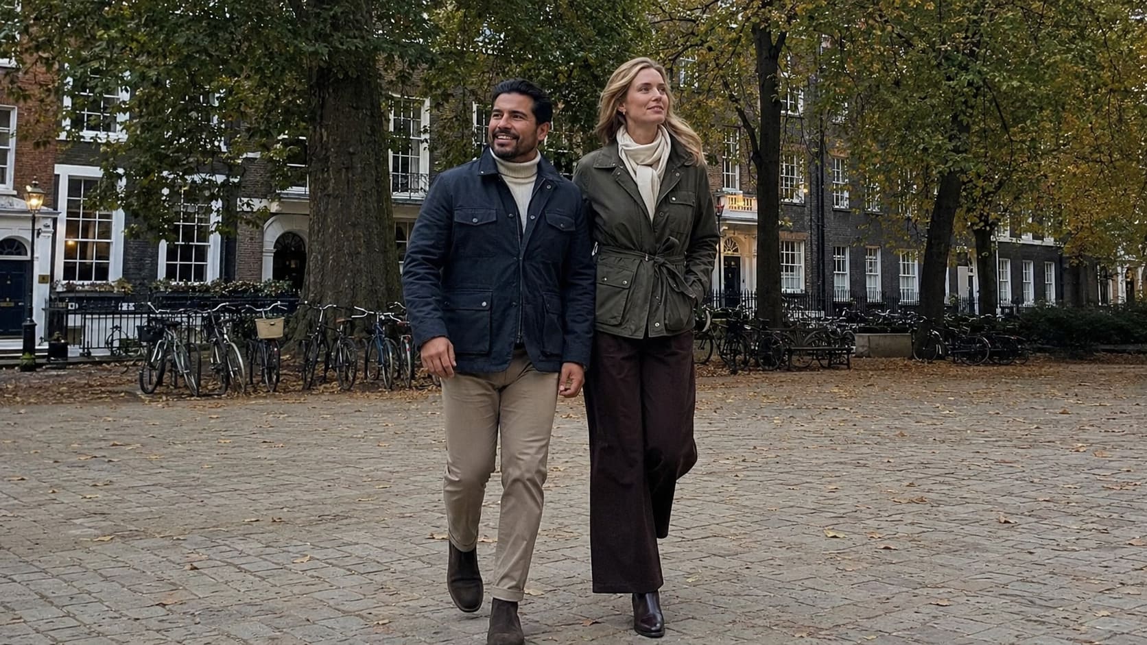 Men wearing navy tailored jackets walk through a city park in cool September weather. Men wearing navy tailored jackets walk through a city park in cool September weather.
