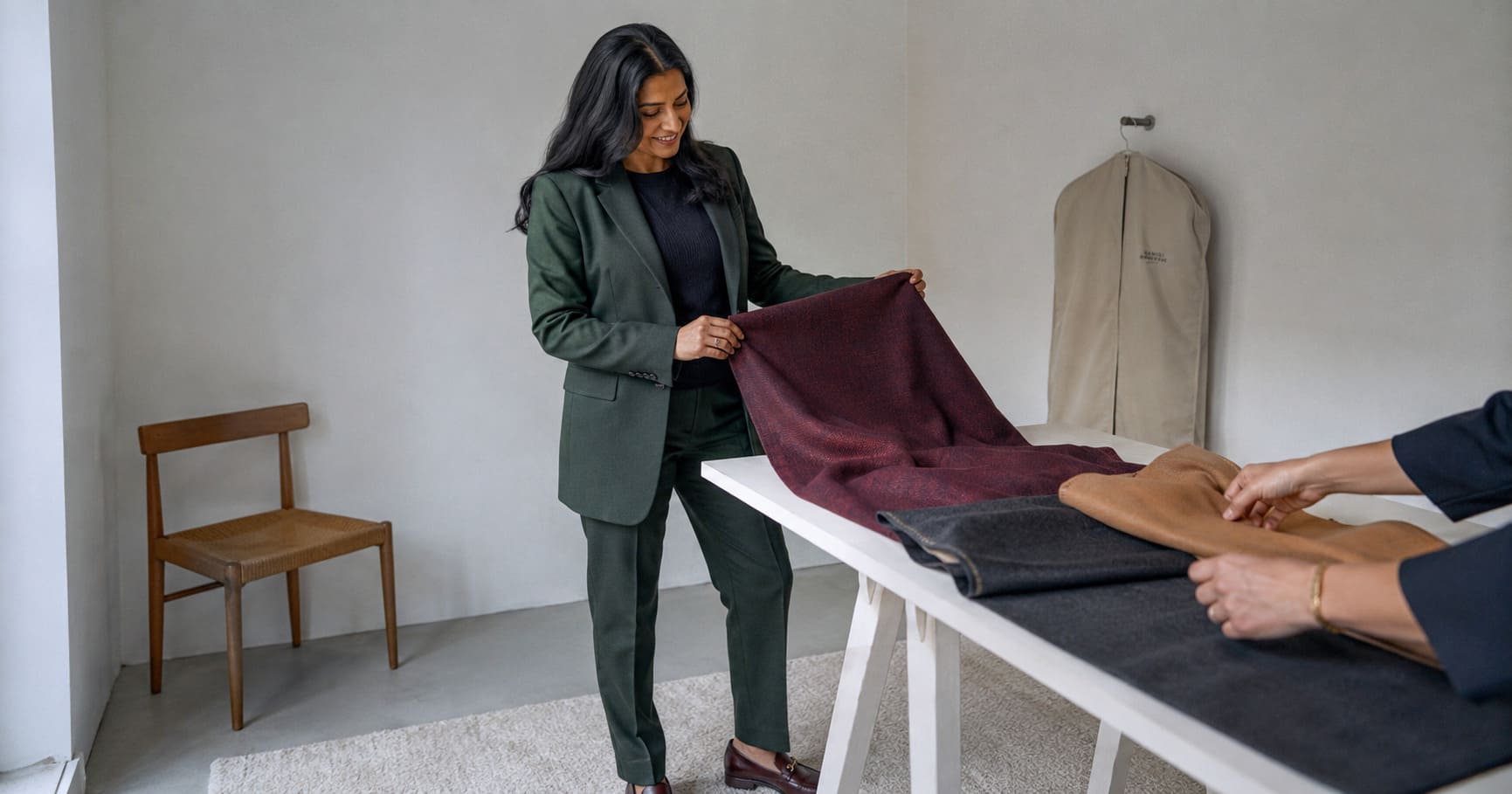 Woman picking bespoke cloth for her new tailored workwear outfit