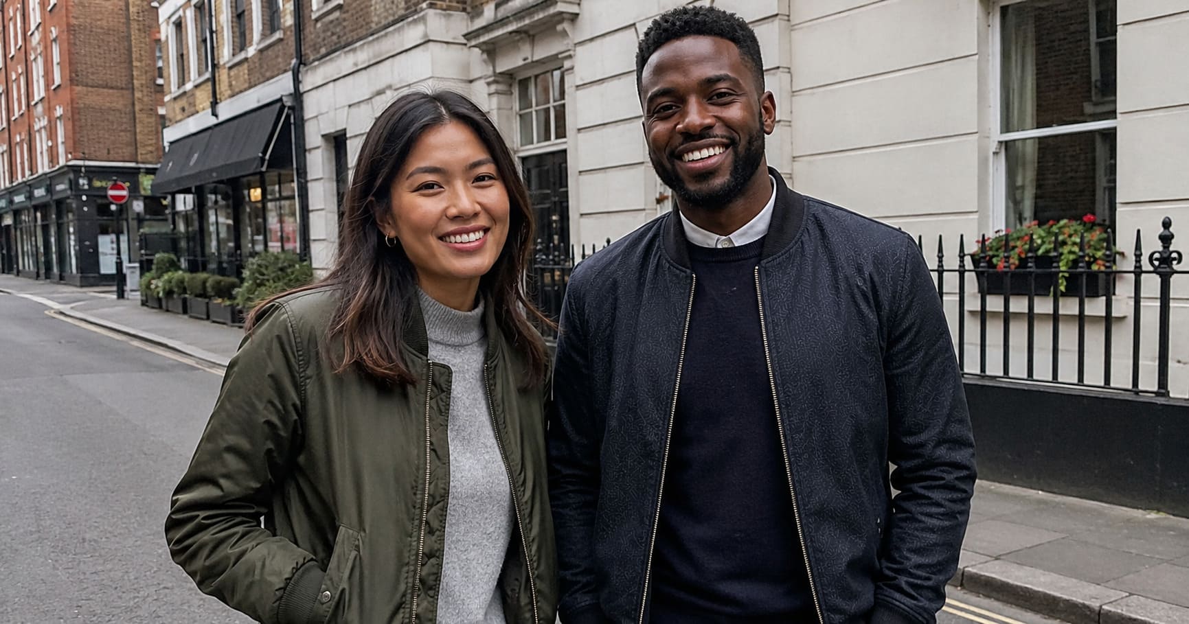 Man and woman in casual tailored jackets on a residential street Man and woman in casual tailored jackets on a residential street